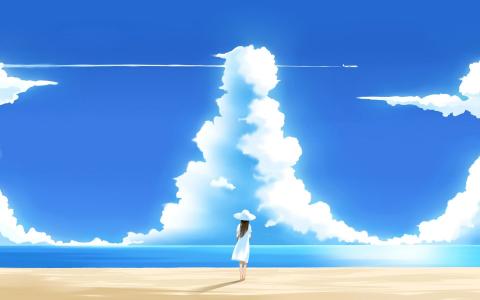 女孩在看着天空的海滩